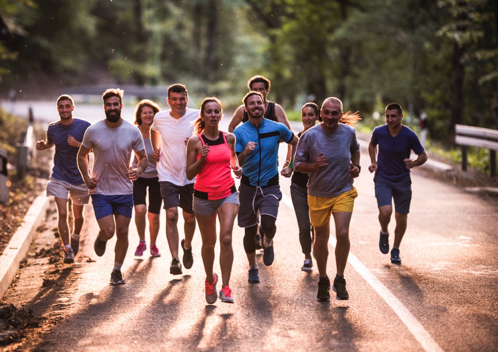 Group of runners on road heading to Sports Med Navigator